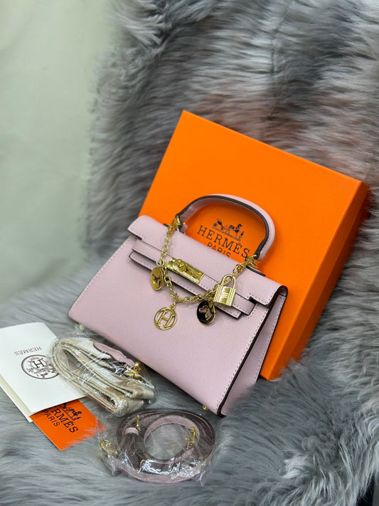 Hermès – Kelly Mini Sellier (Pink) with Charm Chain