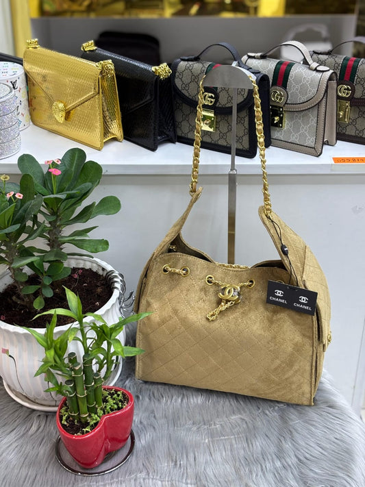 Chanel – Quilted Suede Drawstring Shoulder Bag (Gold)